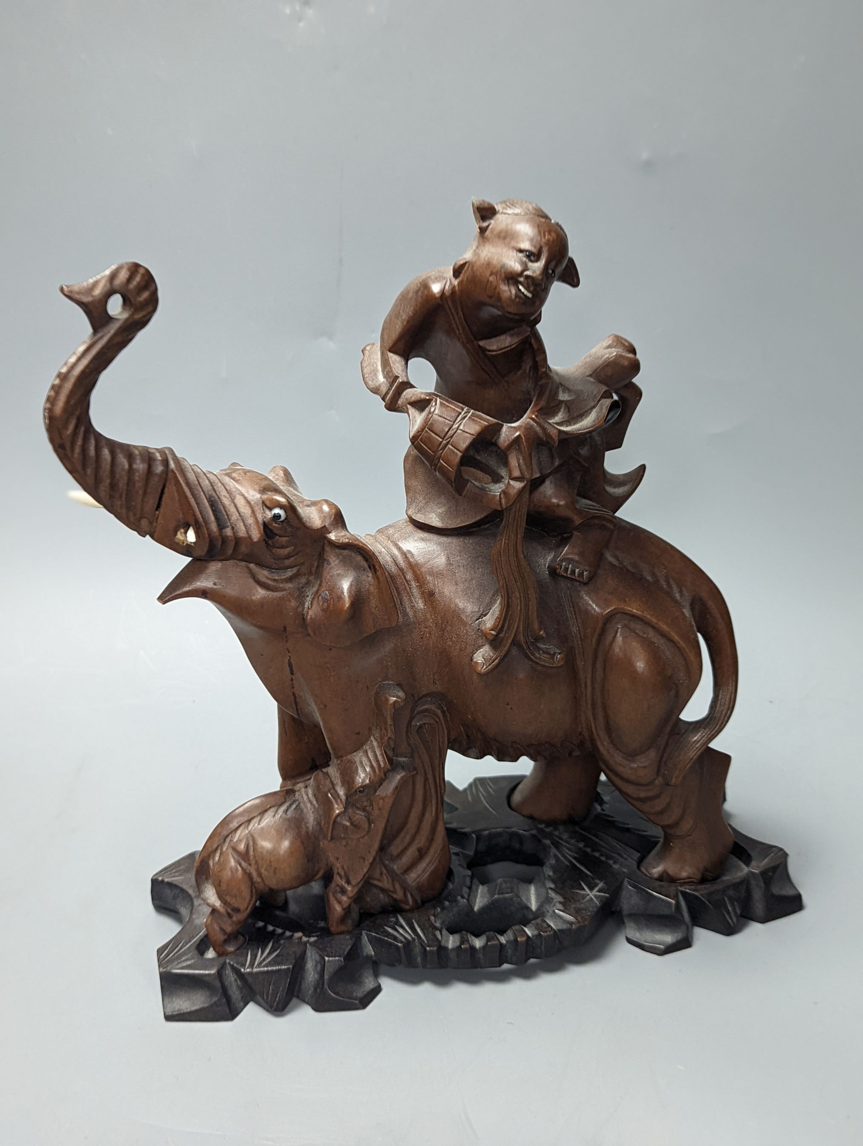 A pair of Chinese wood carvings figures on elephants, a pair of Chinese bear bookends, Chines figures 26 cms high.